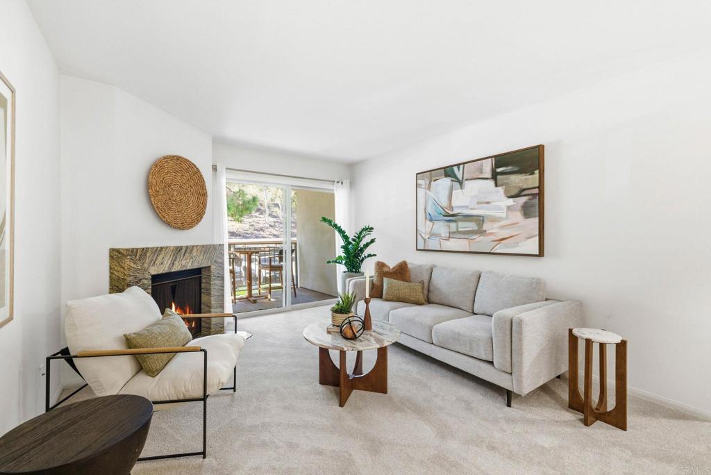 1750 South El Camino Real, Unit 211 Encinitas, CA 92024 - Photo 3 of 44 a living room with furniture a fireplace and a large window