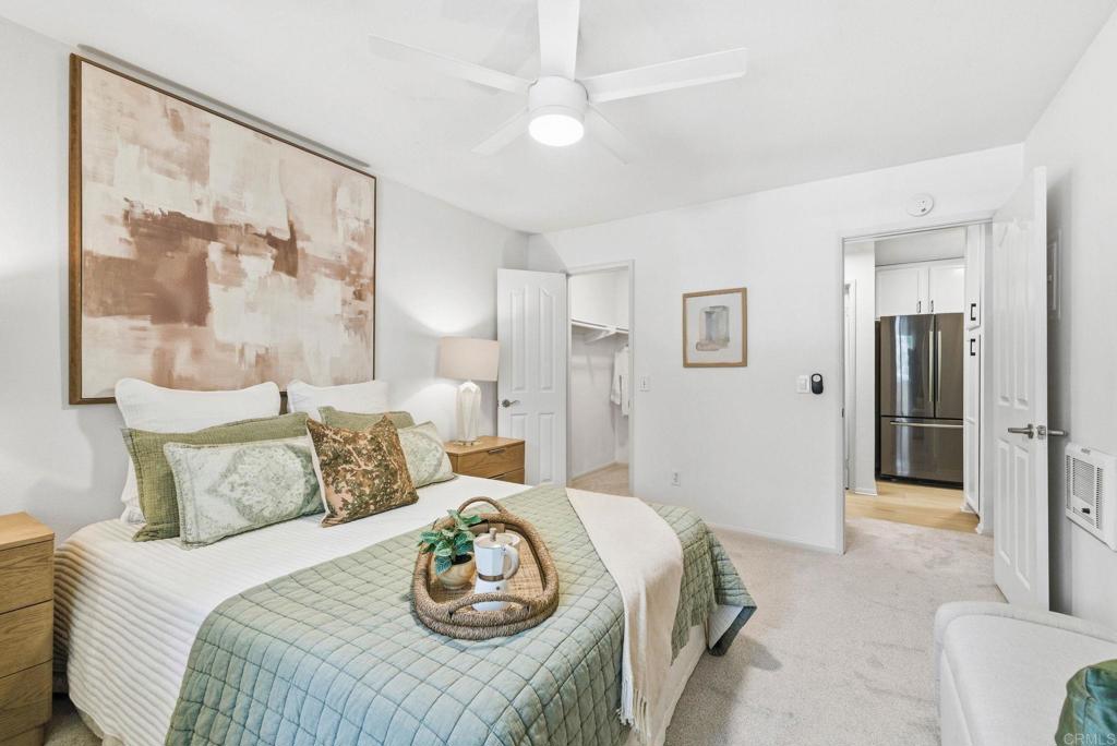 1750 South El Camino Real, Unit 211 Encinitas, CA 92024 - Photo 31 of 44 a bedroom with a bed and a painting on the wall