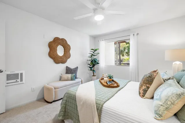 a bedroom with two beds and a chandelier