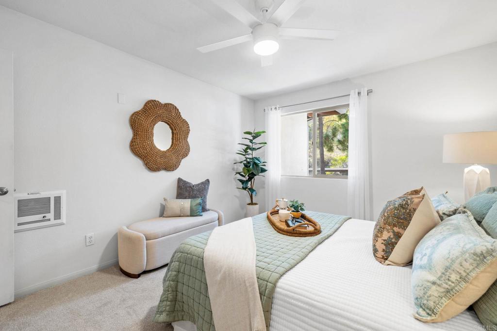 1750 South El Camino Real, Unit 211 Encinitas, CA 92024 - Photo 32 of 44 a bedroom with two beds and a chandelier