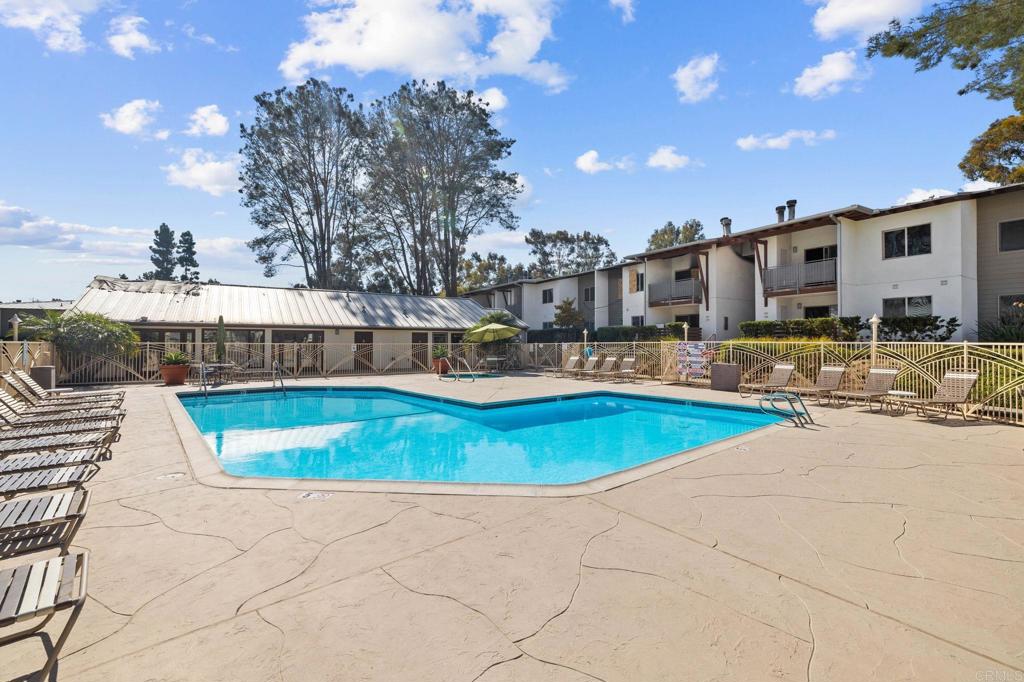 1750 South El Camino Real, Unit 211 Encinitas, CA 92024 - Photo 43 of 44 a swimming pool with outdoor seating and yard