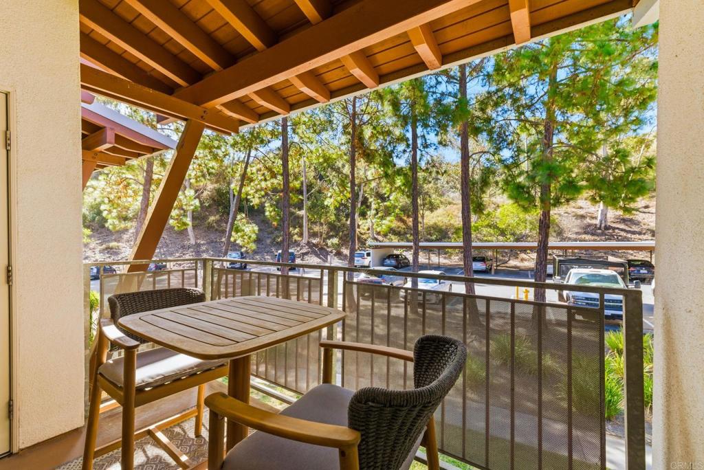 1750 South El Camino Real, Unit 211 Encinitas, CA 92024 - Photo 8 of 44 a view of a chairs and table in patio with a lake view