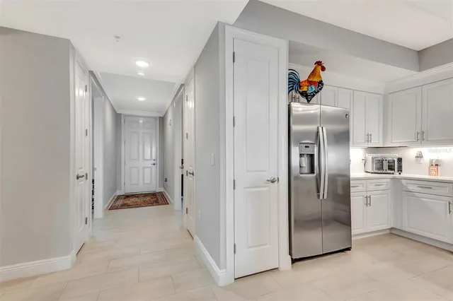 a kitchen with stainless steel appliances granite countertop a refrigerator and a sink