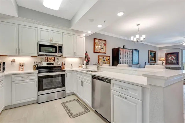 a kitchen with granite countertop a stove top oven sink and cabinets