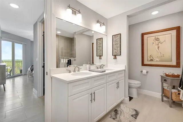 a bathroom with a toilet sink and shower