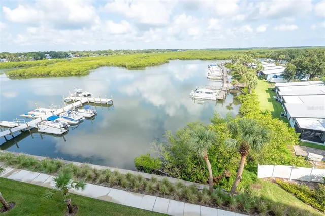 a view of a lake with boats and trees in the background