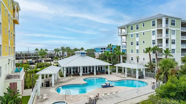 a view of a patio with a table chairs and backyard