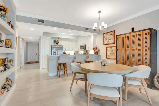 a view of a dining room with furniture and a chandelier