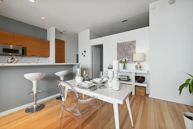 a dining room with furniture and wooden floor