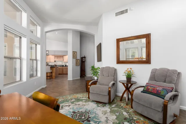 a living room with furniture wooden floor and a large window