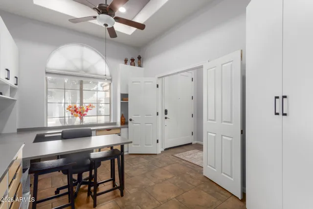 a workspace with wooden floor and a chandelier fan