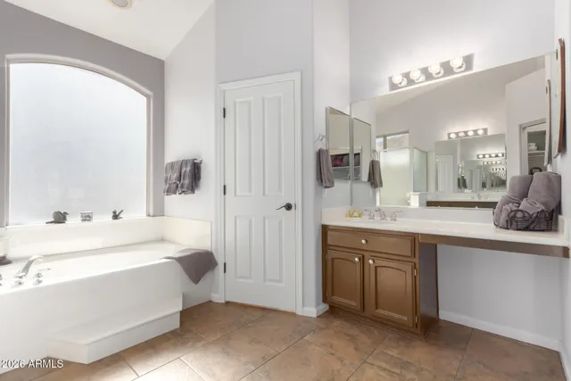 a spacious bathroom with a double vanity sink mirror and double