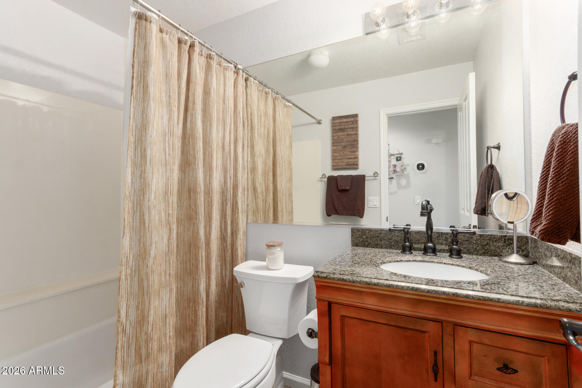 21009 North 16th Way Phoenix, AZ 85024 - Photo 24 of 39 a bathroom with a granite countertop sink a toilet and a mirror