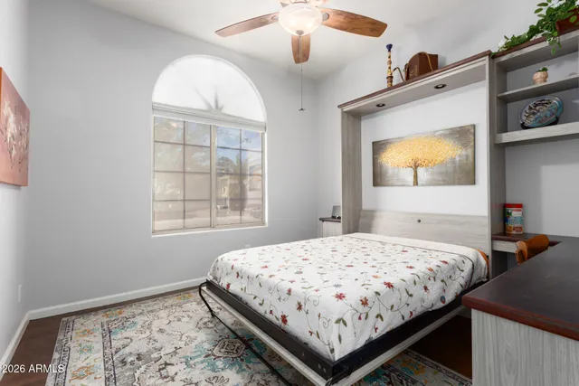 a bedroom with a bed and a painting on the wall