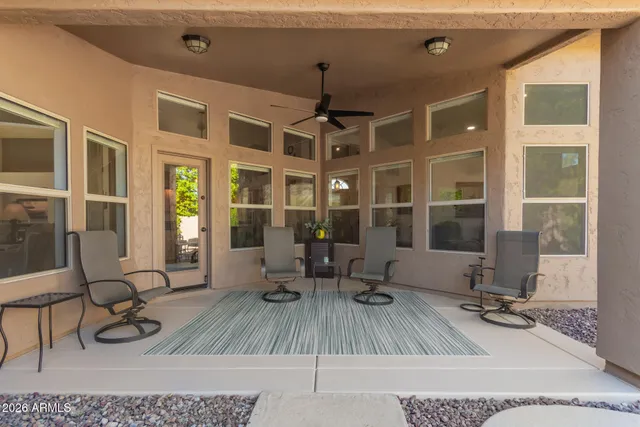 a view of a patio with a table and chairs under an umbrella