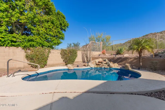 a house with swimming pool in front of it