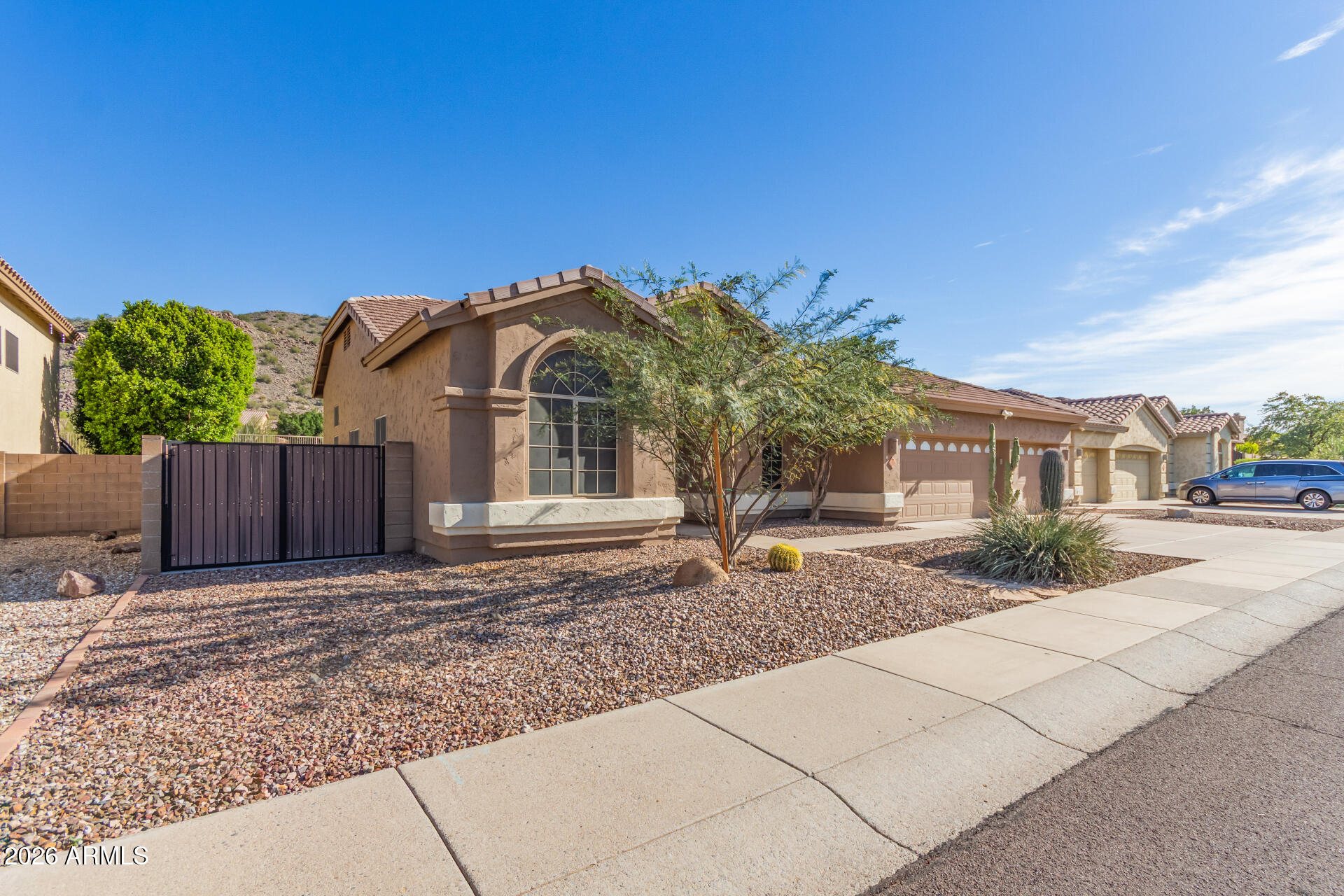 21009 North 16th Way Phoenix, AZ 85024 - Photo 38 of 39 a front view of a house with a yard and potted plants