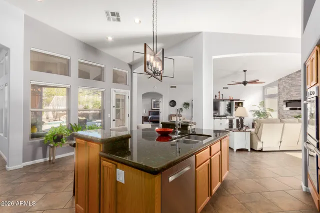 a kitchen with stove cabinets and chandelier
