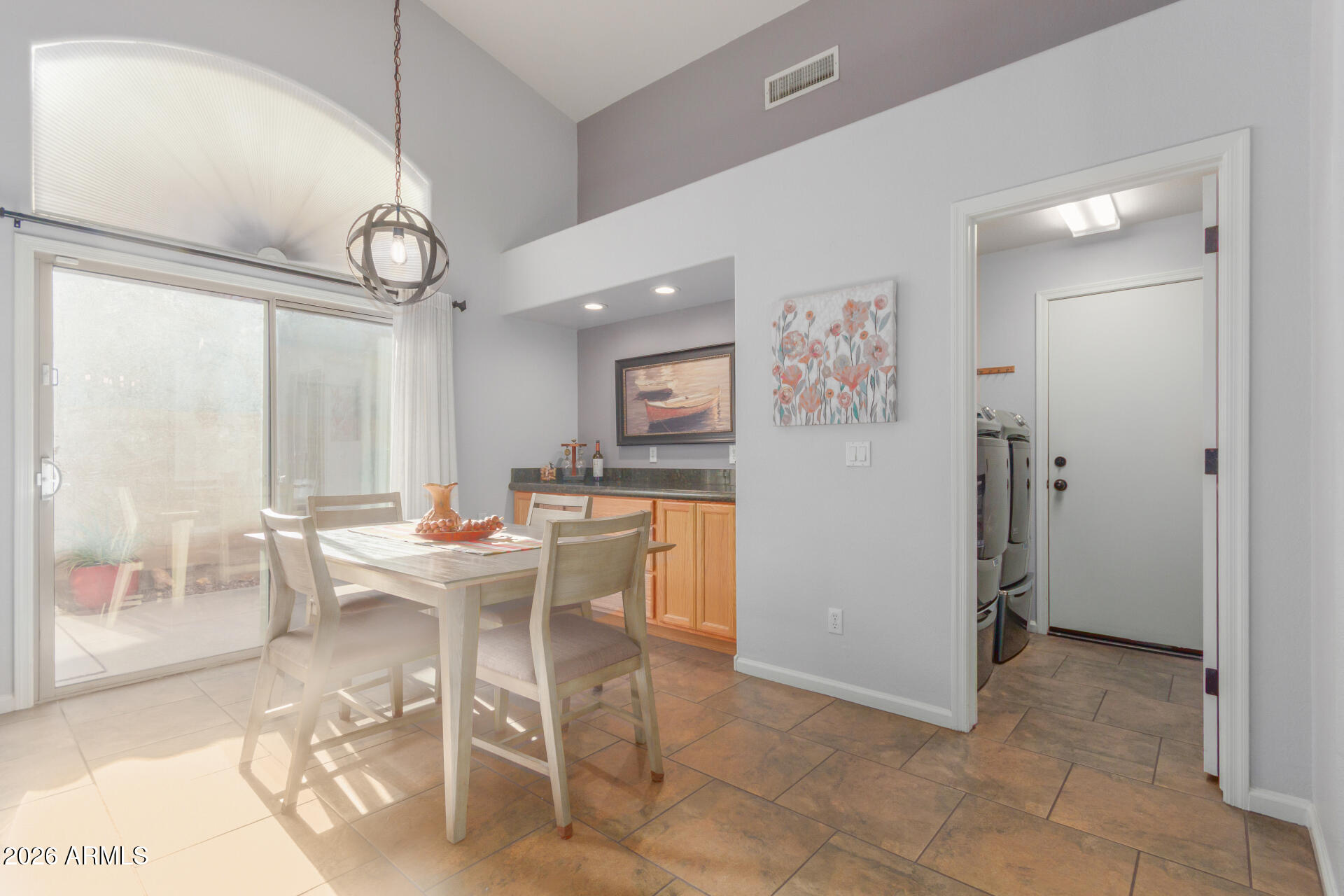 21009 North 16th Way Phoenix, AZ 85024 - Photo 9 of 39 a view of a dining room with furniture window and wooden floor