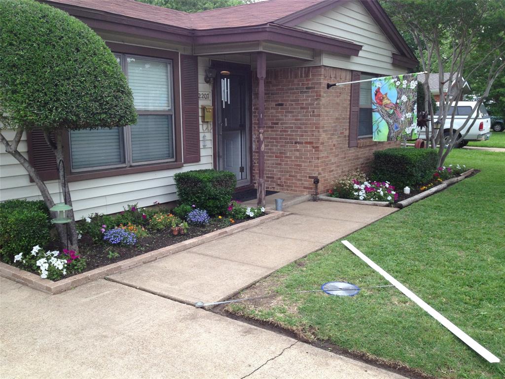 2207 Finley Road Irving, TX 75062 - Photo 1 of 1 a front view of a house with a garden