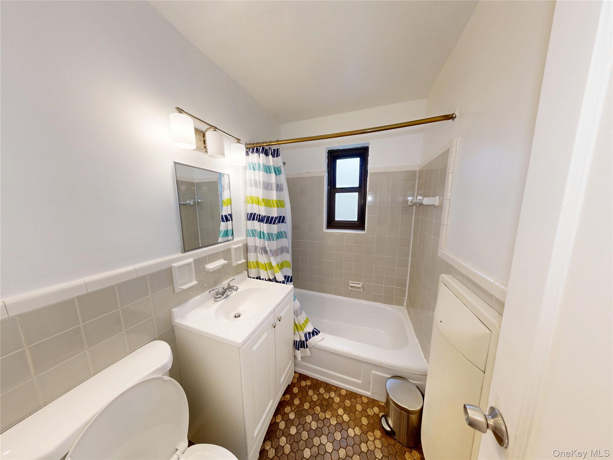 61 White Oak Street, Unit 3A New Rochelle, NY 10801 - Photo 2 of 12 a bathroom with a sink a toilet and shower