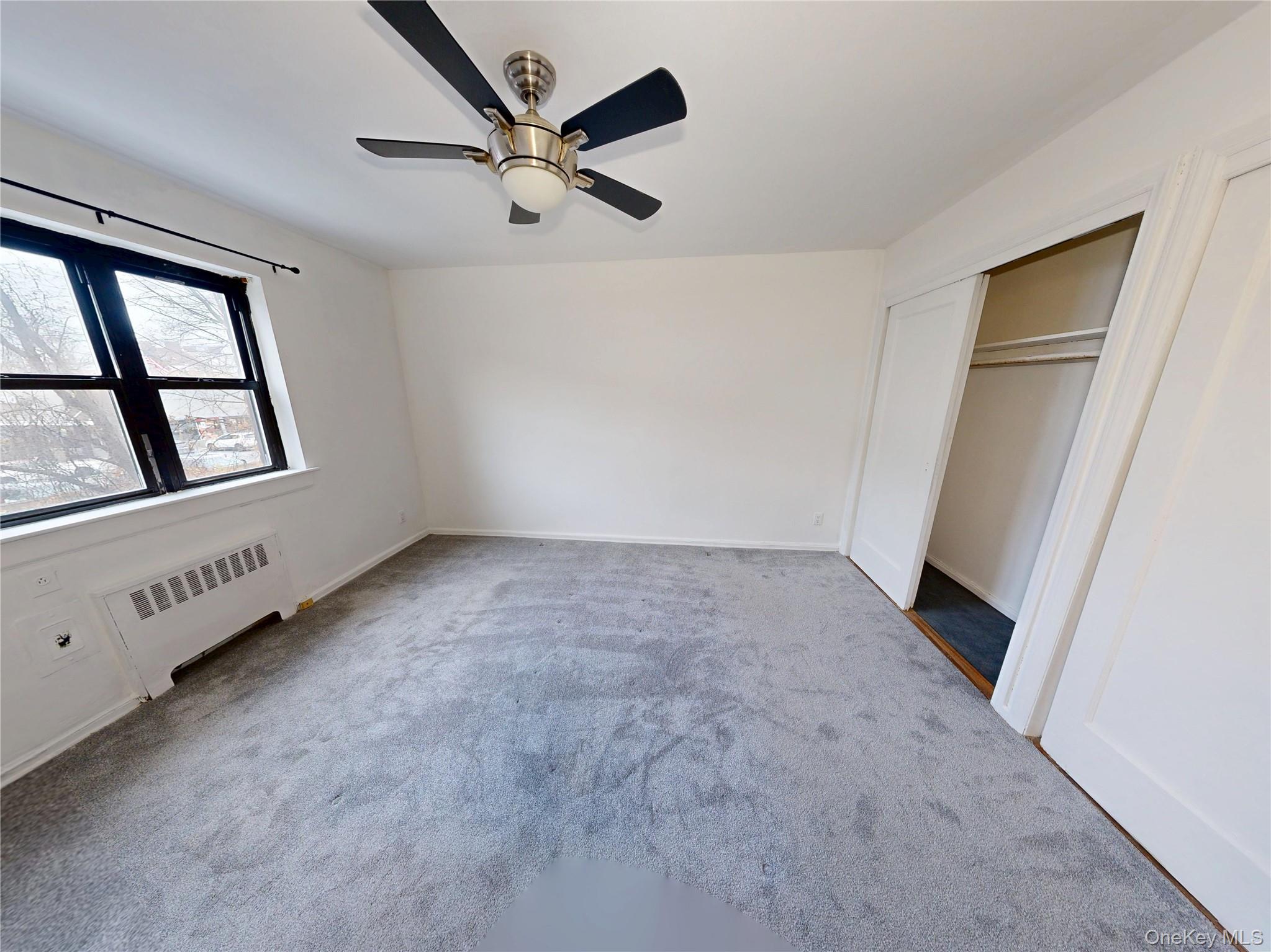 61 White Oak Street, Unit 3A New Rochelle, NY 10801 - Photo 4 of 12 wooden floor in an empty room with a window