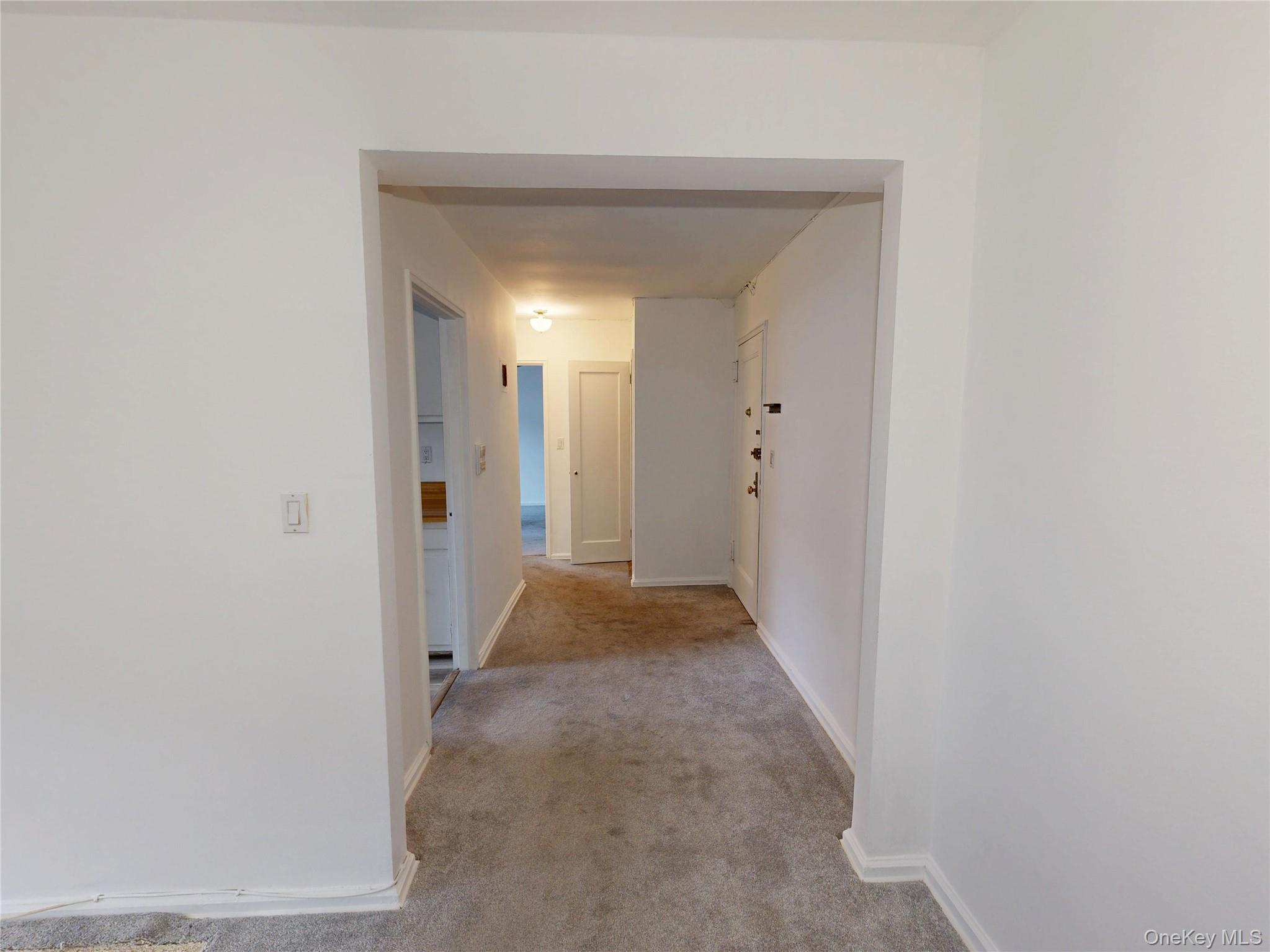 61 White Oak Street, Unit 3A New Rochelle, NY 10801 - Photo 6 of 12 a view of a hallway with wooden floor