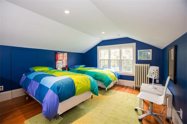 19 Cushing Road Wellesley, MA 02481 - Photo 24 of 29 a bedroom with a bed and a chair