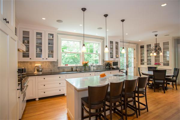 19 Cushing Road Wellesley, MA 02481 - Photo 4 of 29 a kitchen with stainless steel appliances granite countertop a stove a sink a dining table chairs and view living room