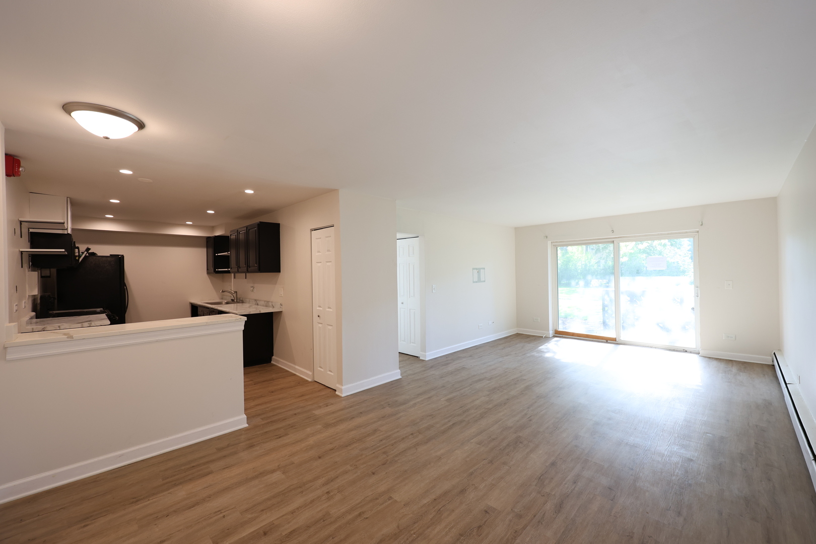 2230 South Goebbert Road, Unit 139 Arlington Heights, IL 60005 - Photo 4 of 14 a view of kitchen with wooden floor and electronic appliances