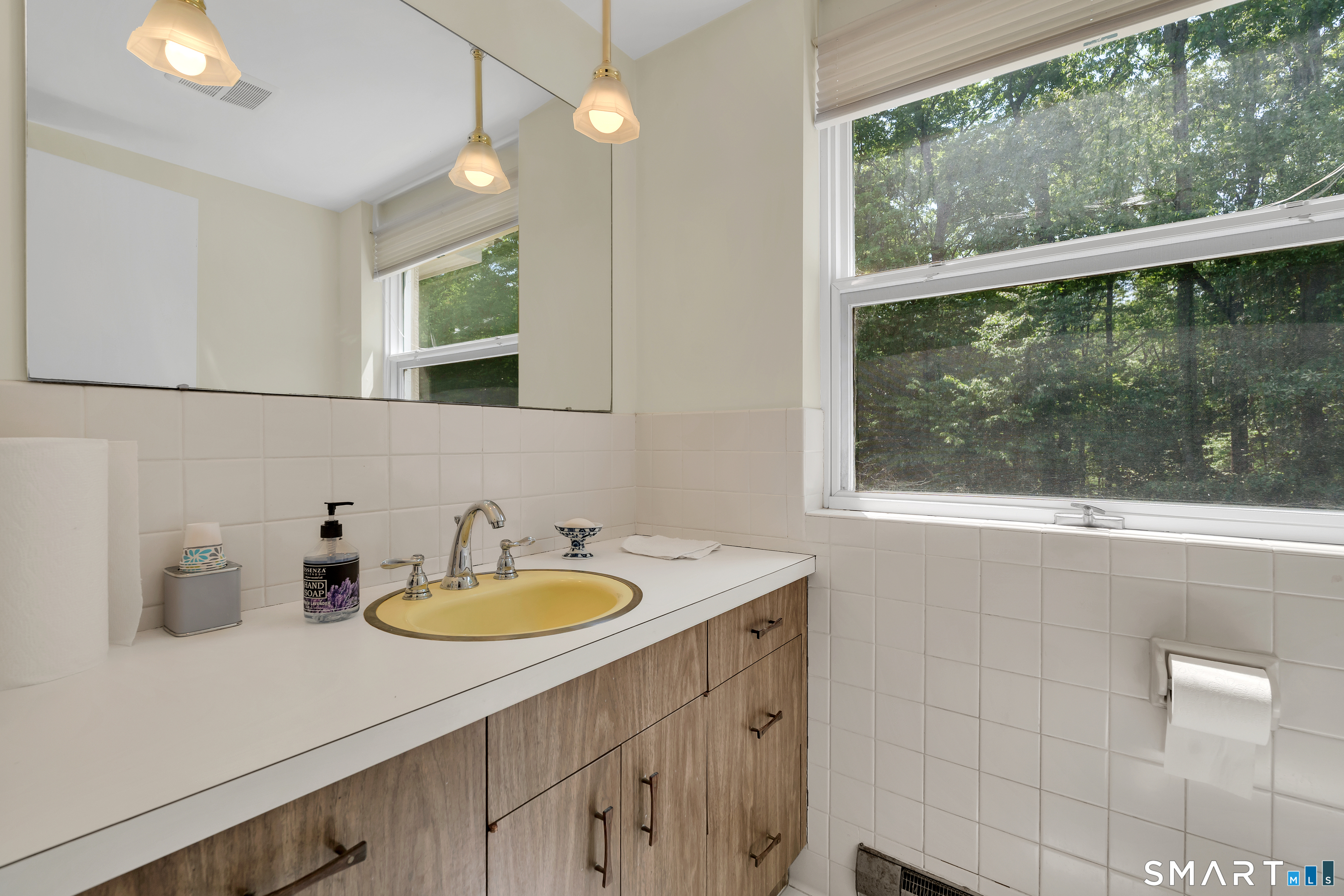 30 Maltbie Road Newtown, CT 06470 - Photo 35 of 40 a bathroom with a sink a mirror and a window