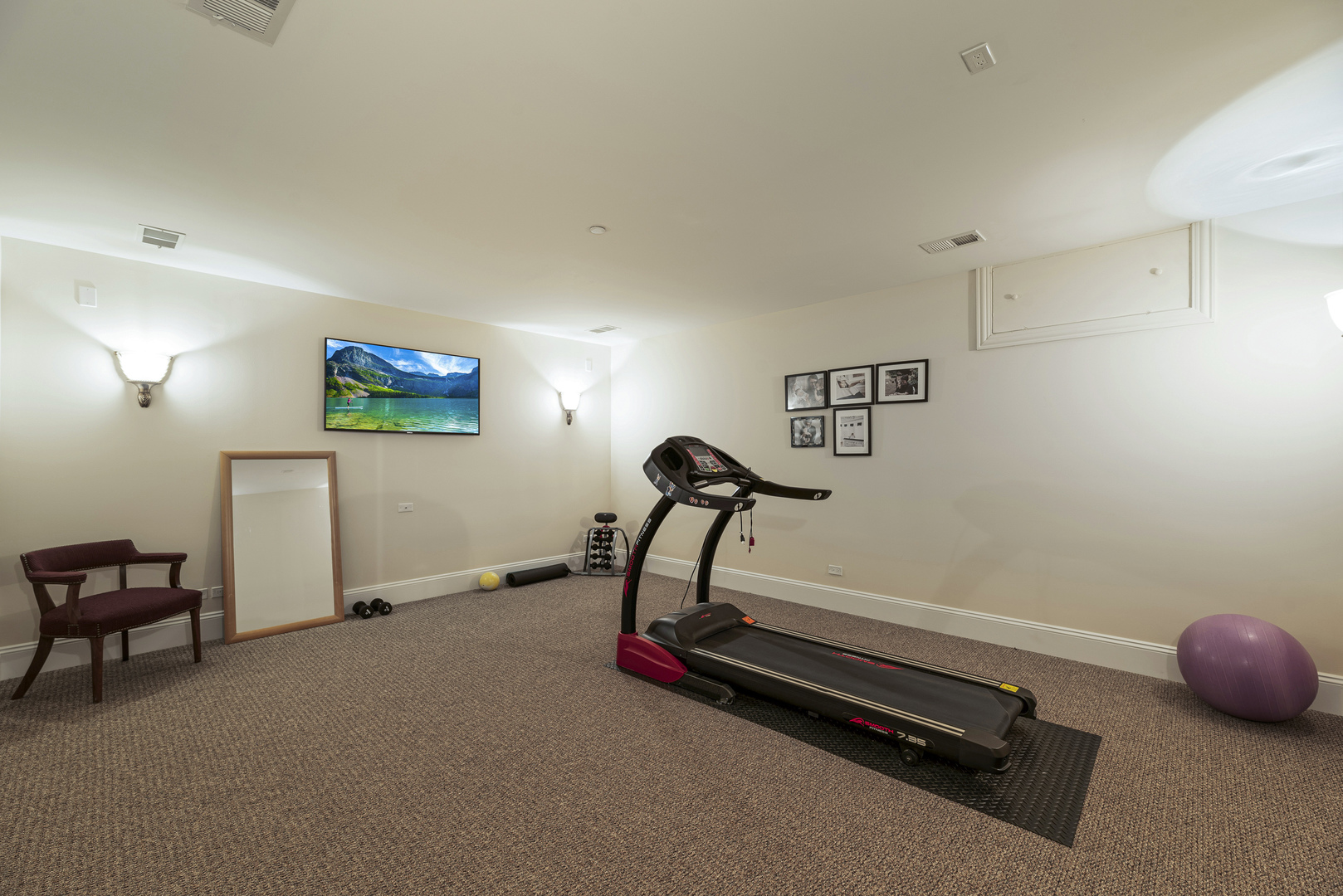3372 Lakeside Avenue Northbrook, IL 60062 - Photo 33 of 41 a room with gym equipment and a chandelier