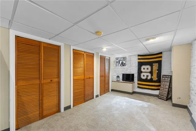 a view of an empty room with window and furniture