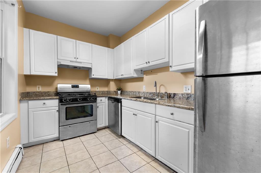 1815 Wharton Street Pittsburgh, PA 15203 - Photo 3 of 15 a kitchen with white cabinets and white appliances