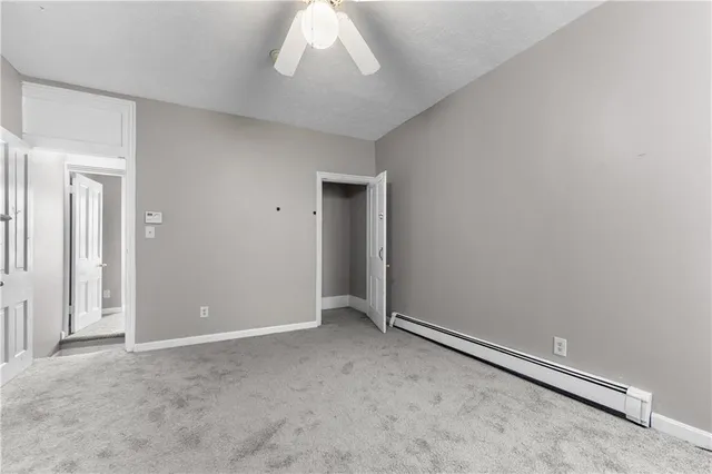 an empty room with a chandelier fan