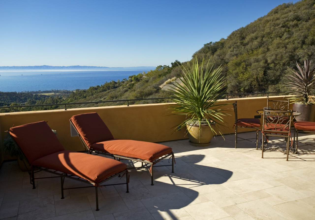 891 Toro Canyon Road Montecito, CA 93108 - Photo 3 of 11 a balcony with table and chairs