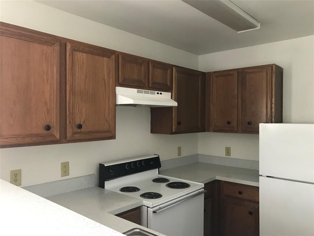 a kitchen with a cabinets and a stove top oven