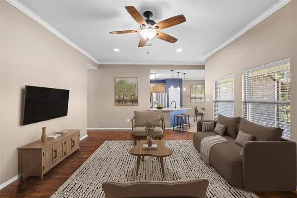 a view of a livingroom with a ceiling fan and window