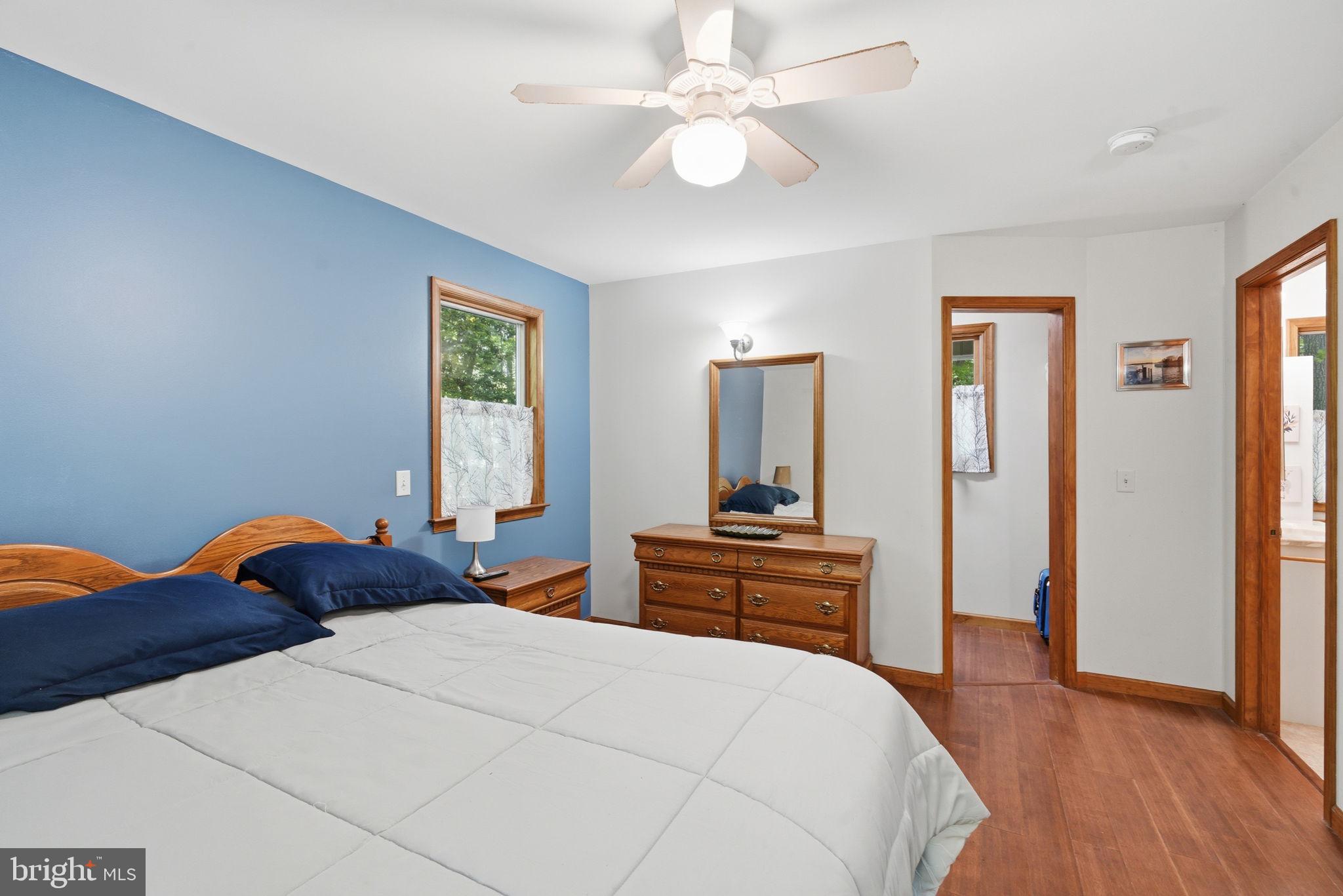22300 Frazier Road Rock Hall, MD 21661 - Photo 16 of 38 a bedroom with a bed and wooden floor