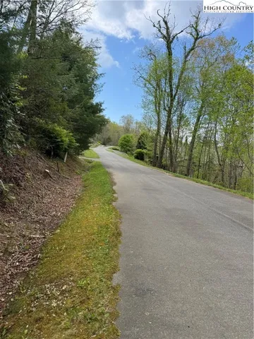 a view of a sign under a tree