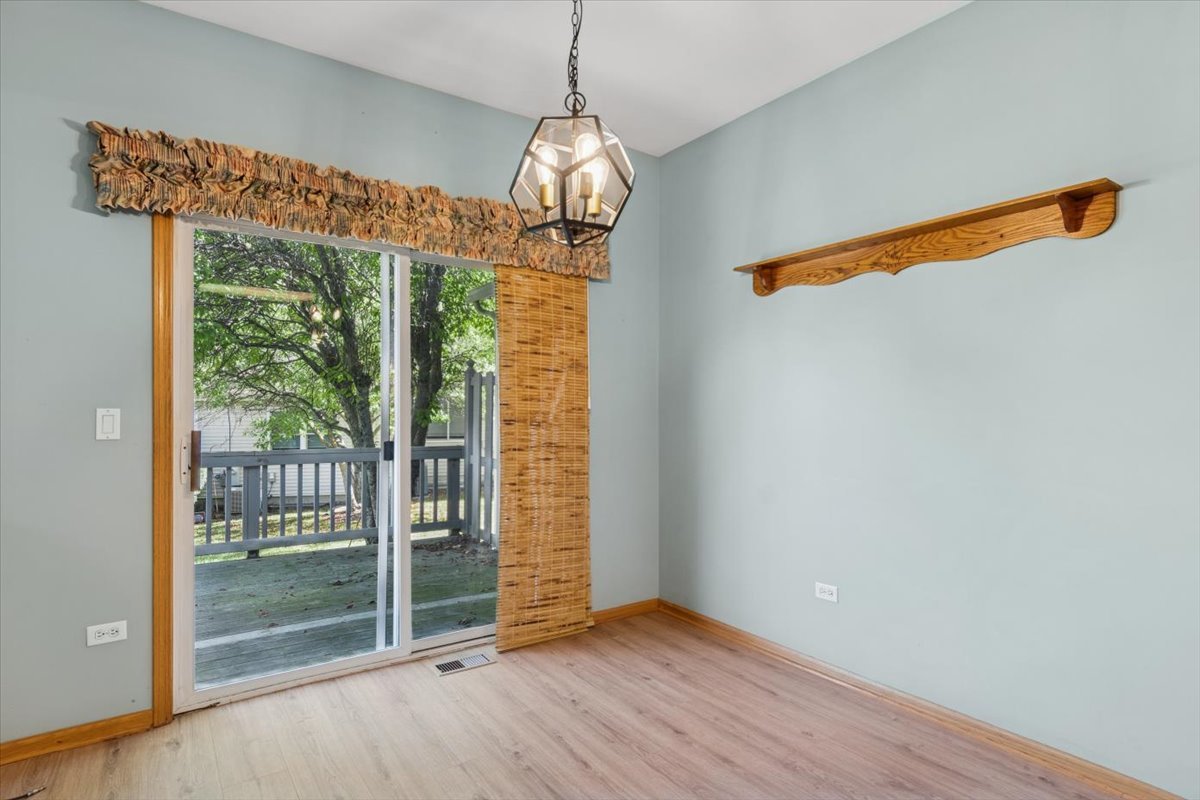 20928 West Spruce Lane Plainfield, IL 60544 - Photo 11 of 20 a view of a hallway with wooden floor and a chandelier