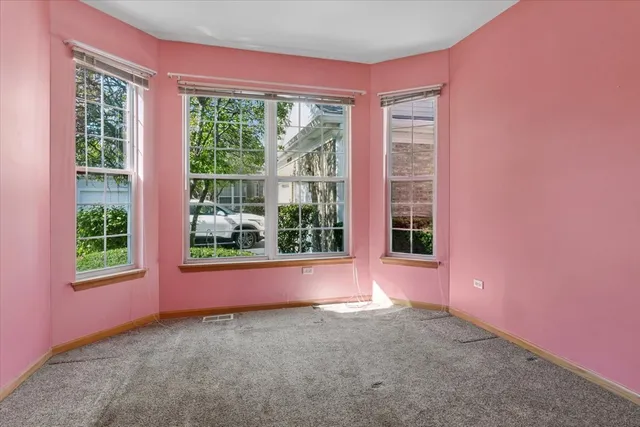 an empty room with a empty space and windows