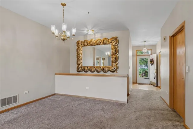 an empty room with windows and cabinet