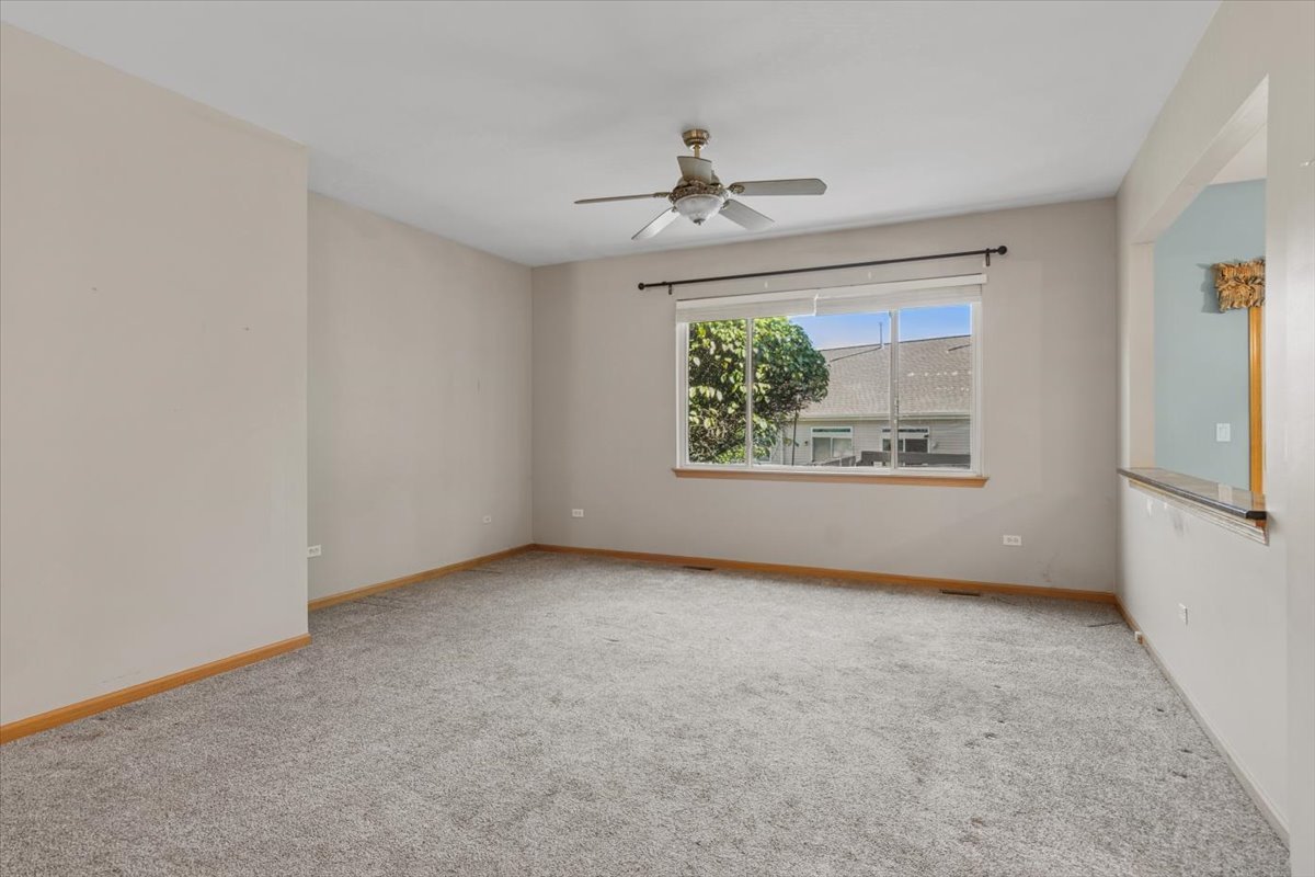 20928 West Spruce Lane Plainfield, IL 60544 - Photo 5 of 20 an empty room with a window and a ceiling fan