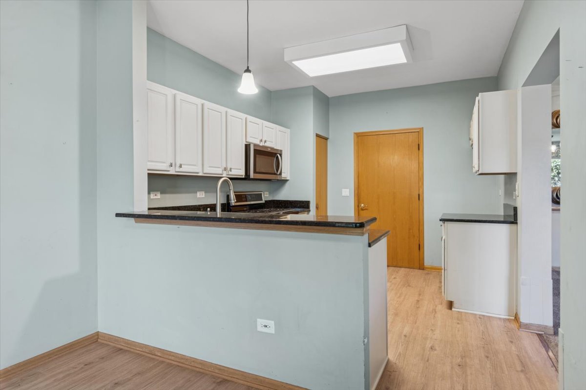 20928 West Spruce Lane Plainfield, IL 60544 - Photo 10 of 20 a kitchen with stainless steel appliances a refrigerator a stove a microwave and cabinets