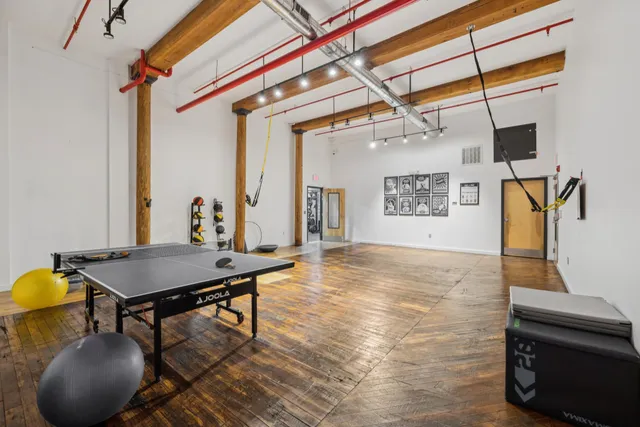 a view of a house with wooden deck and furniture