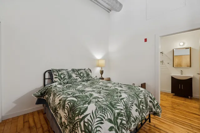 a bedroom with a bed and a dresser