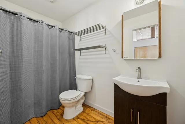 a bathroom with a toilet a sink and a mirror