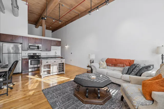 a living room with furniture and a kitchen view