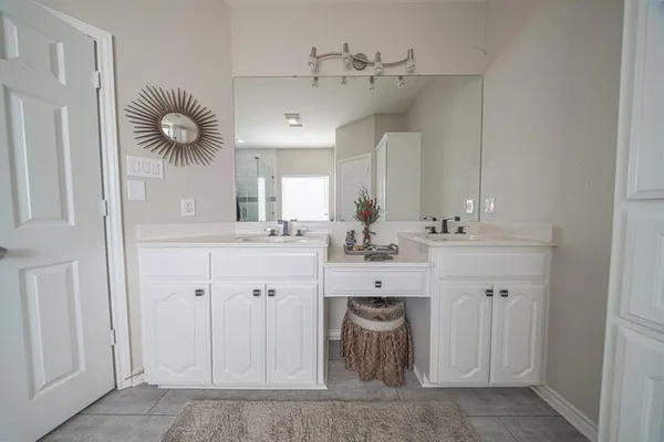 a bathroom with a sink vanity and mirror